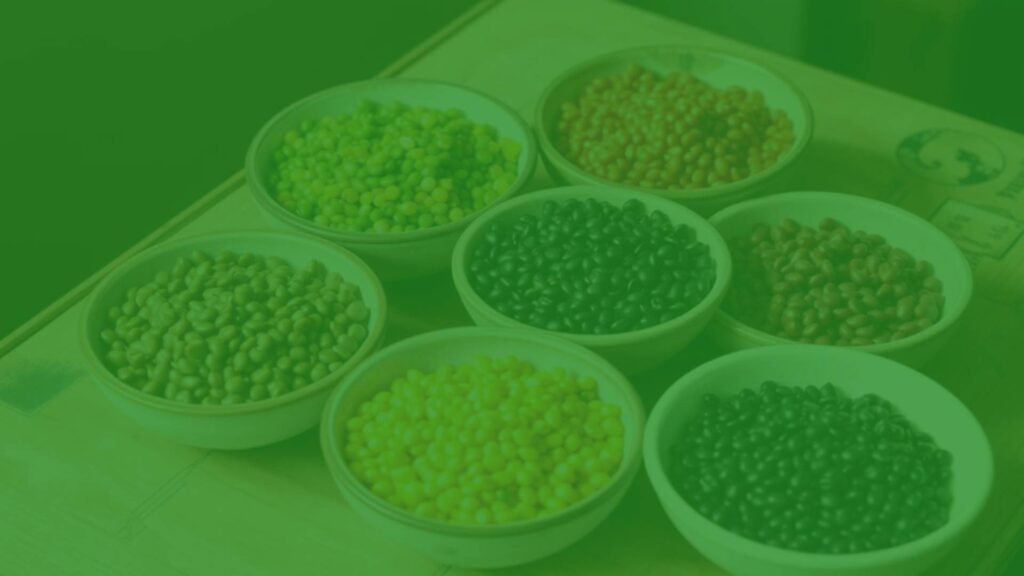 Assortment of colorful lentils in bowls, including brown, green, red, yellow, and black, arranged neatly on a wooden table, rustic and natural lighting, realistic.