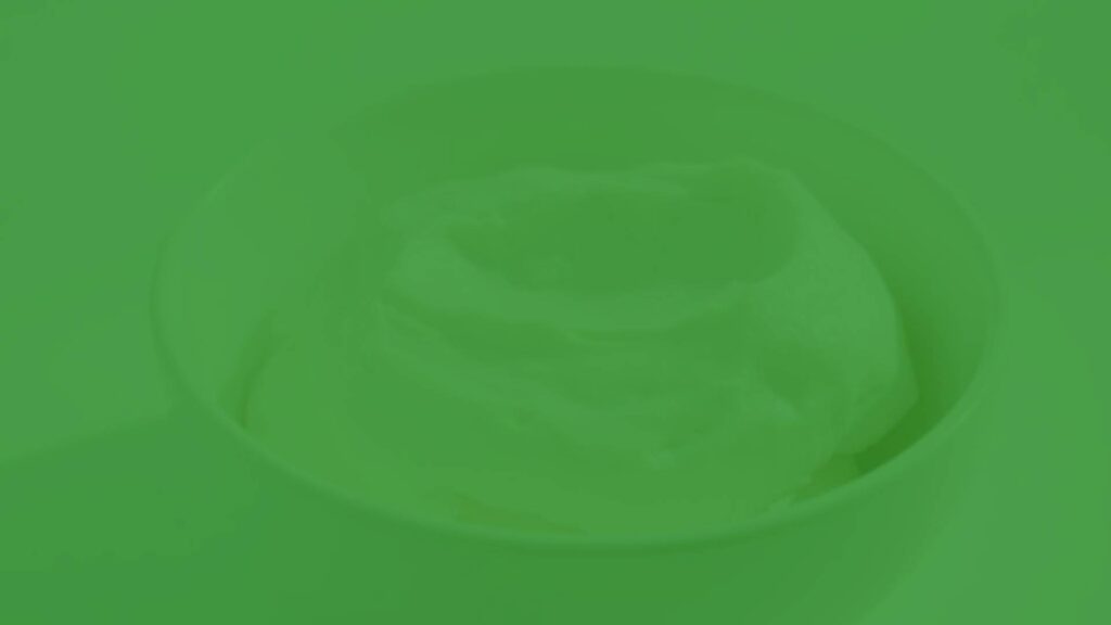 Silken tofu in a white bowl, soft and creamy texture, delicate and smooth, subtle off-white color, minimalist background, natural lighting, realistic.