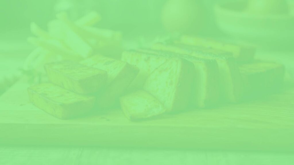 A close-up of smoked tofu slices on a wooden cutting board, with a rustic kitchen background, soft natural lighting, realistic.