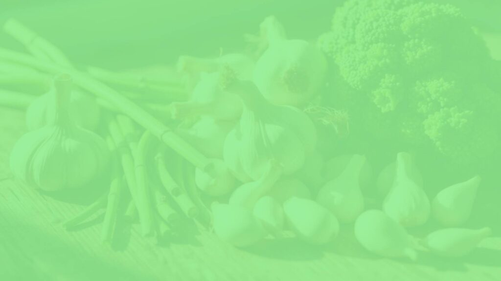 Fresh plant-based sulfur-rich foods like garlic, onions, and broccoli arranged neatly on a wooden table, natural sunlight, vibrant colors, healthy lifestyle vibe.